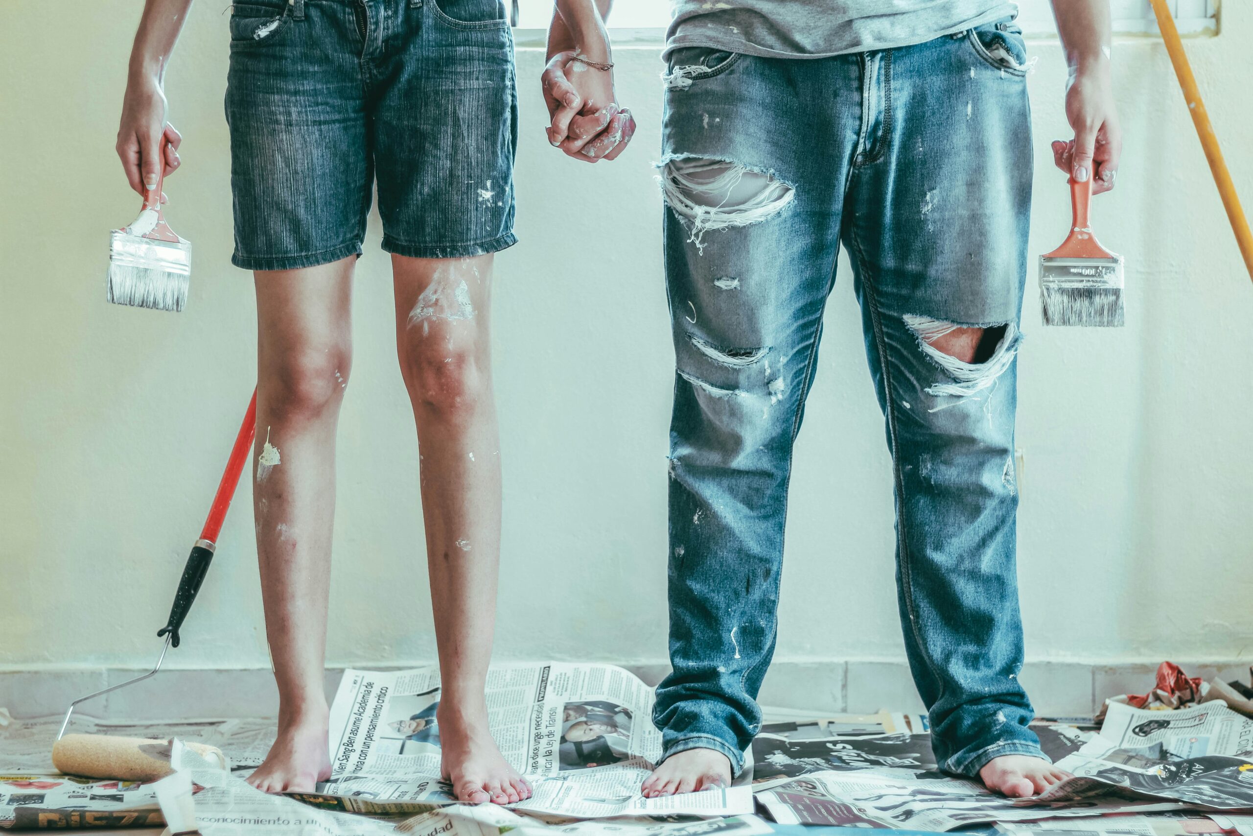 Photo of a couple in the middle of a DIY project on Whidbey Island covered in paint. Charged with a Misdemeanor in Island County? Why You Should NOT Try to DIY Your Defense